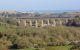 The night sleeper sweeps over Angarrack viaduct as nears end of journey to Penzance; in distance lie dunes of Hayle Towans; beyond them sea of St Ives bay, | Craig Munday | 20 Apr 2015.